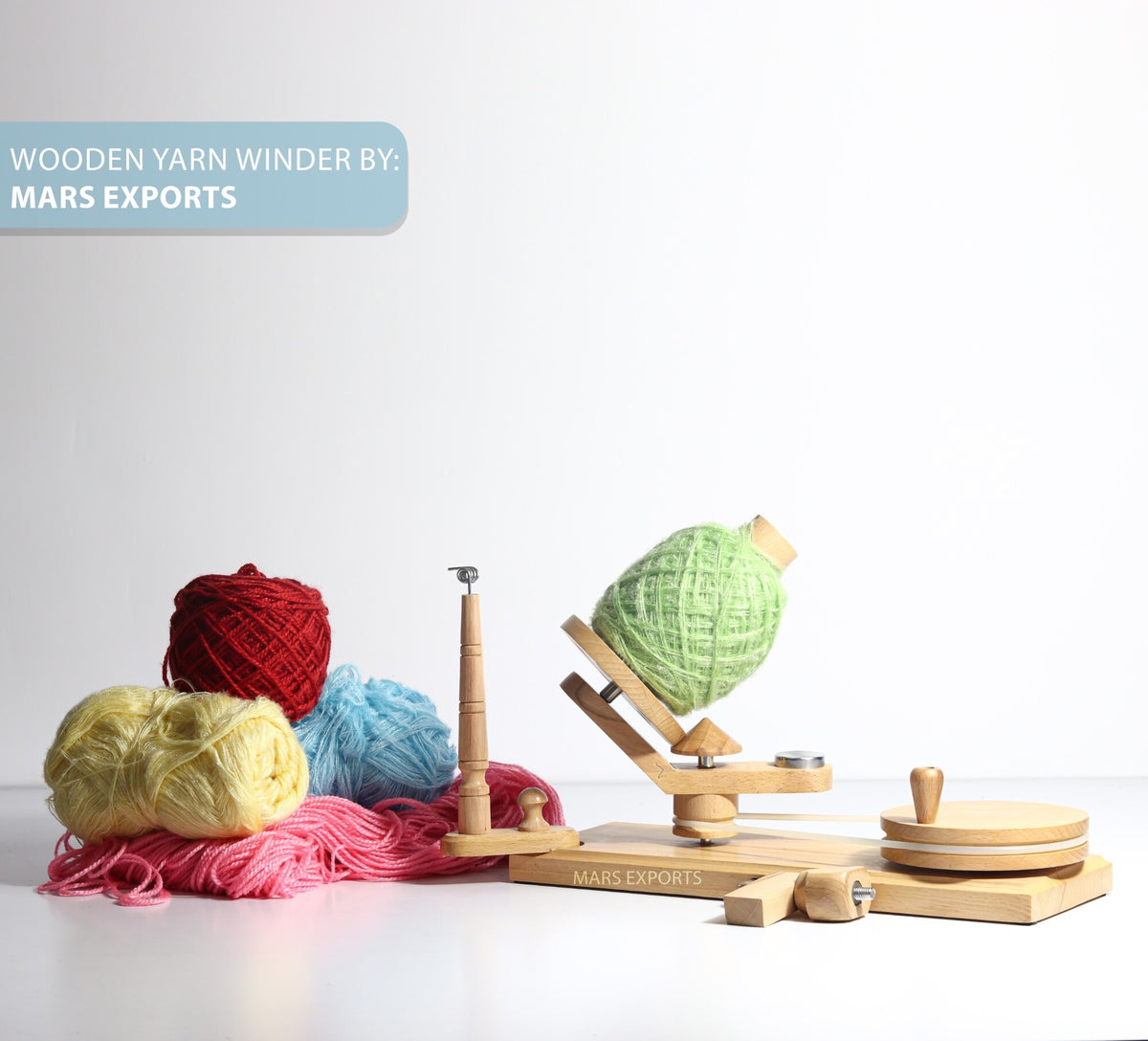 Clamp-mounted beechwood yarn winder in a knitting and crochet workspace